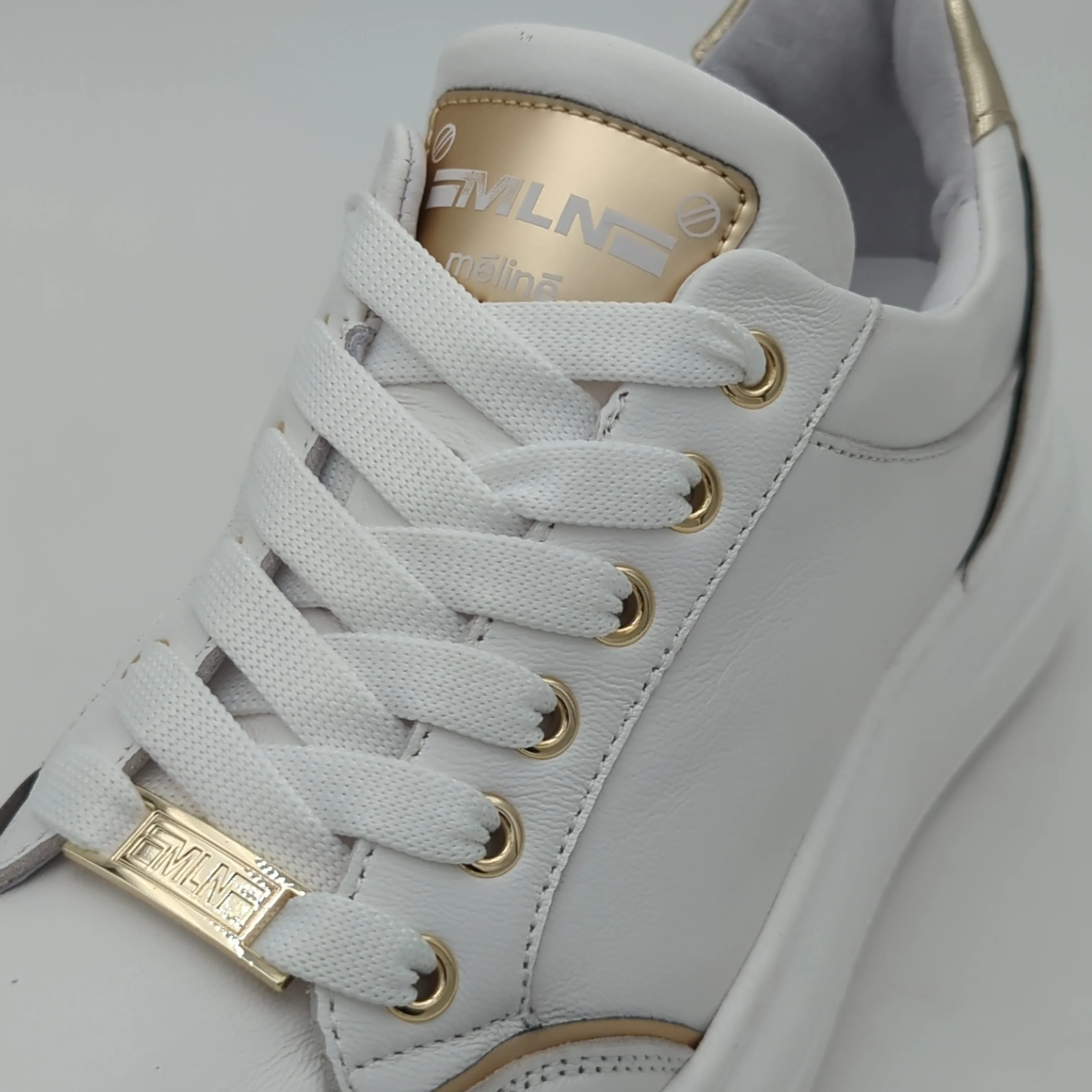 White Trainer with Gold Detailing by Meline