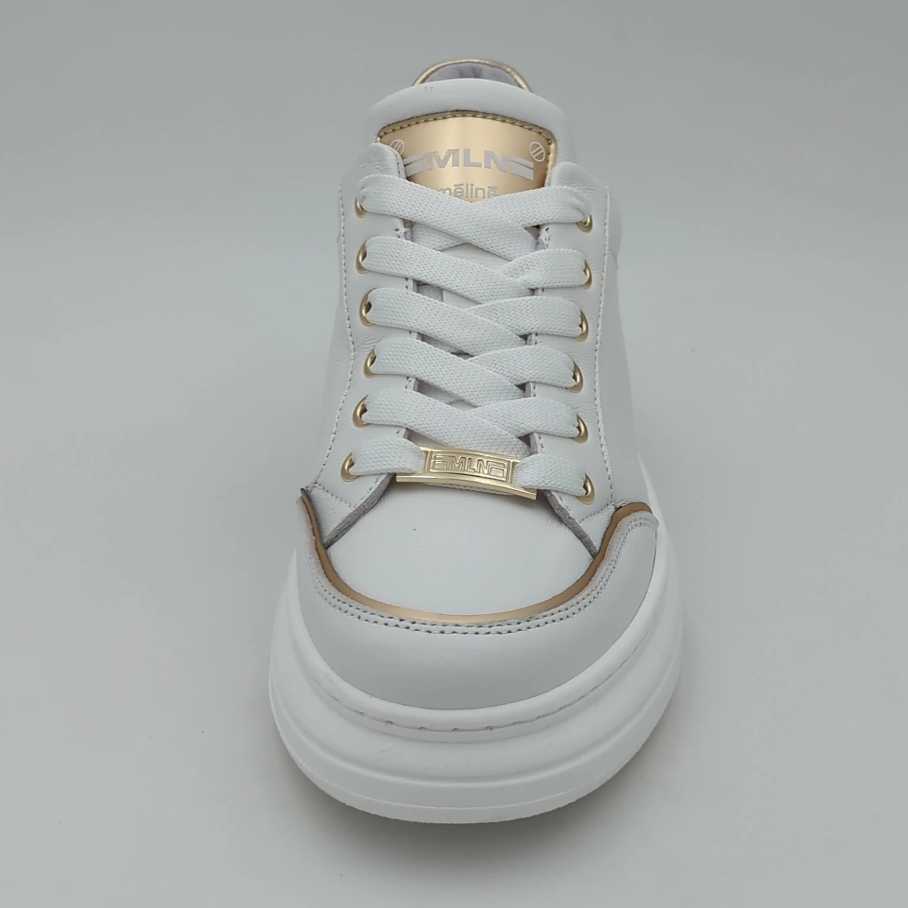 White Trainer with Gold Detailing by Meline